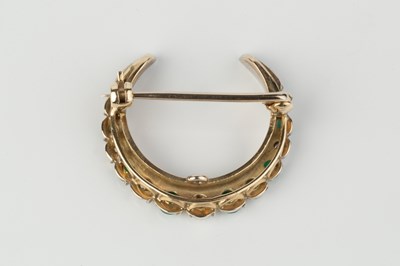Lot 108 - An emerald and diamond crescent brooch, set...