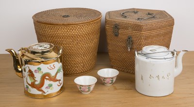 Lot 192 - Two wicker work baskets incorporating teapots...