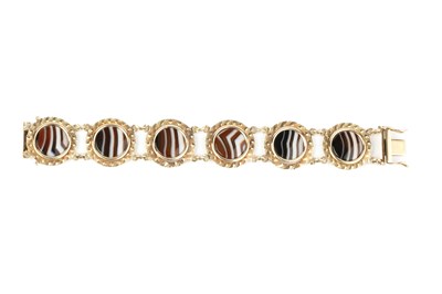 Lot 40 - A banded agate panel bracelet, each circular...