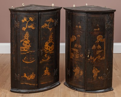 Lot 99 - A matched pair of Georgian black lacquered chinoiserie corner cabinets