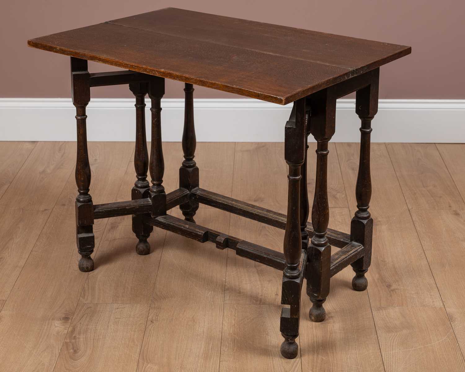 Lot 75 - A small 17th or 18th century oak fold-over gateleg table