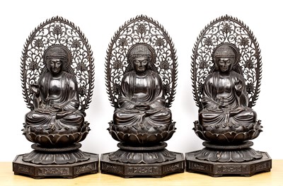 Lot 414 - Three carved hardwood buddhas Chinese, late...