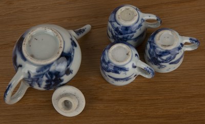 Lot 111 - Miniature blue and white teapot and three cups...