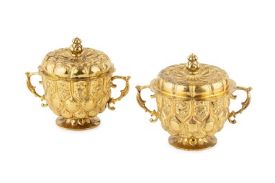 Lot A pair of George V silver-gilt twin handled...