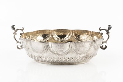 Lot A white metal twin handled bowl, of lobed oval...