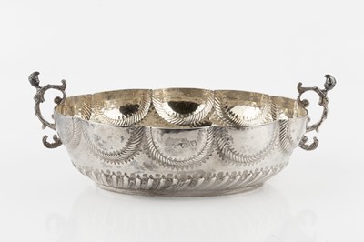 Lot A white metal twin handled bowl, of lobed oval...