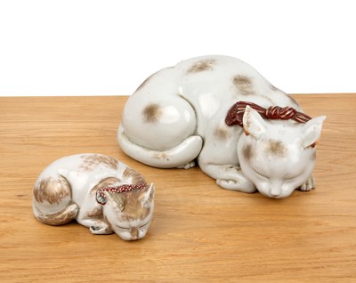 Lot 170 - Two porcelain recumbent cats Japanese, Meiji...