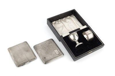 Lot 244 - Two silver cigarette cases, with engine turned...