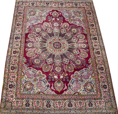 Lot 183 - A Persian Kirman polychrome carpet with a...