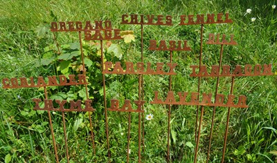 Lot 1337 - A set of twelve steel herb markers