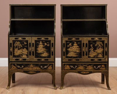 Lot 219 - A pair of black lacquer chinoiserie decorated waterfall bookcases