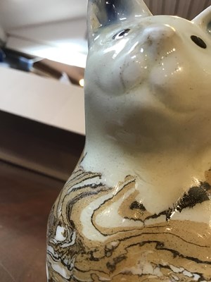 Lot 216 - A 19th century agate ware pottery cat, with...
