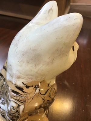 Lot 216 - A 19th century agate ware pottery cat, with...