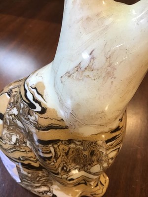 Lot 216 - A 19th century agate ware pottery cat, with...
