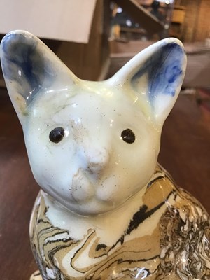 Lot 216 - A 19th century agate ware pottery cat, with...