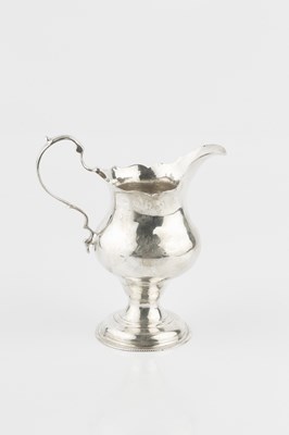 Lot 302 - A George III silver cream jug, with shaped...