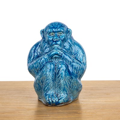 Lot 445 - Turquoise porcelain model of a seated monkey...