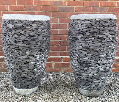 Lot 1253 - A pair of slate and cast reconstituted stone cylindrical garden planters or urns