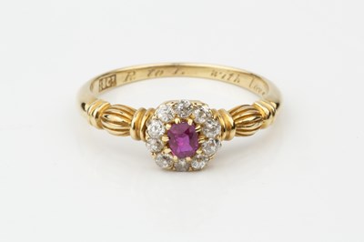 Lot A ruby and diamond cluster ring, the central...