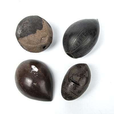 Lot 142 - Four antique tribal nuts, two with engraved...