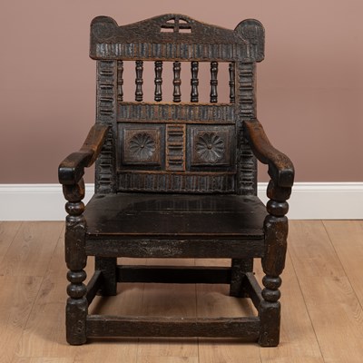 Lot 199 - A 17th century Scottish style oak panel backed armchair