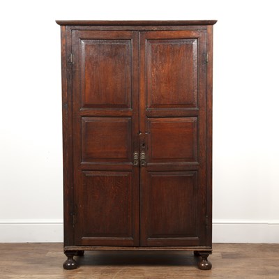 Lot 1 - Oak cupboard with three-panelled doors opening...