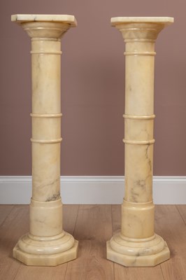 Lot 386 - A pair of turned marble torchères