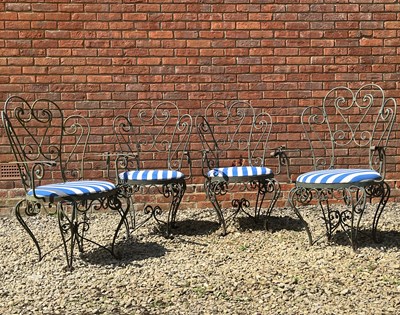 Lot 1235 - A set of four green painted wrought iron garden armchairs