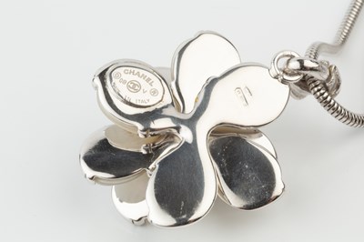 Lot A silver and mother o'pearl 'camellia' pendant...