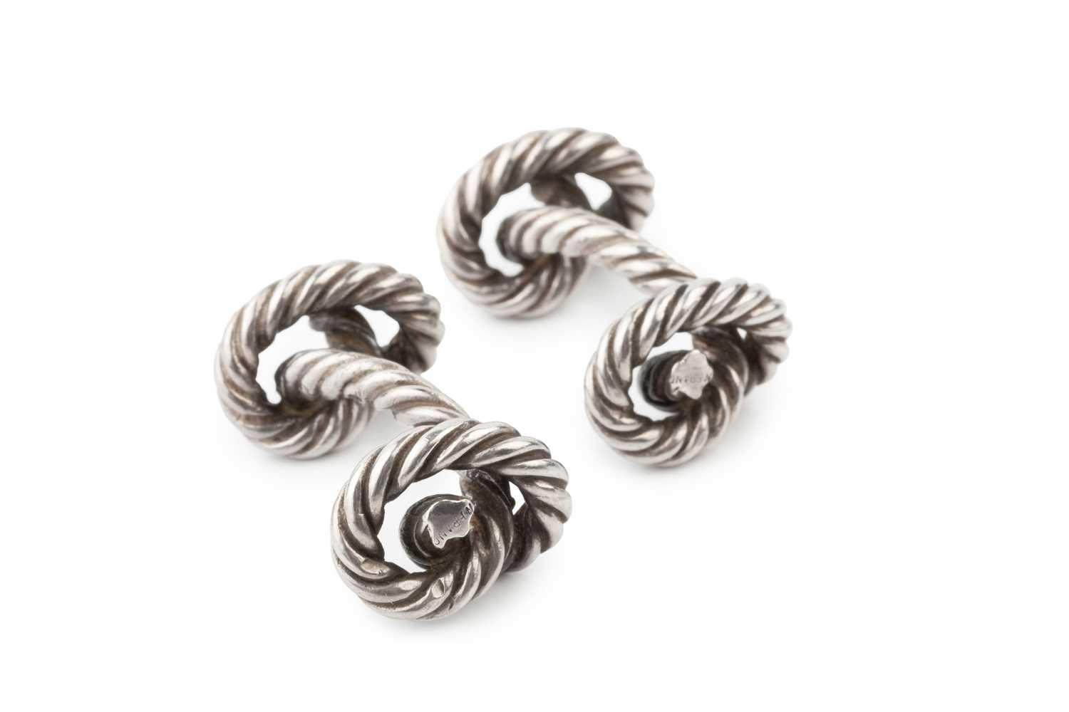 Lot A pair of silver knot cufflinks by Hermes, of...