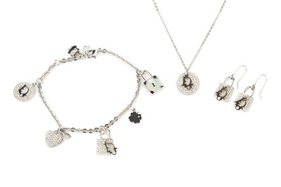 Lot 106 - A paste set charm bracelet by Christian Dior,...