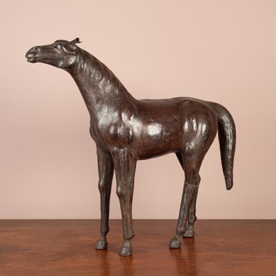 Lot 1030 - A Liberty & Co vintage leather covered wooden model of a horse