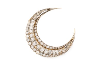 Lot A diamond crescent brooch, designed as three...