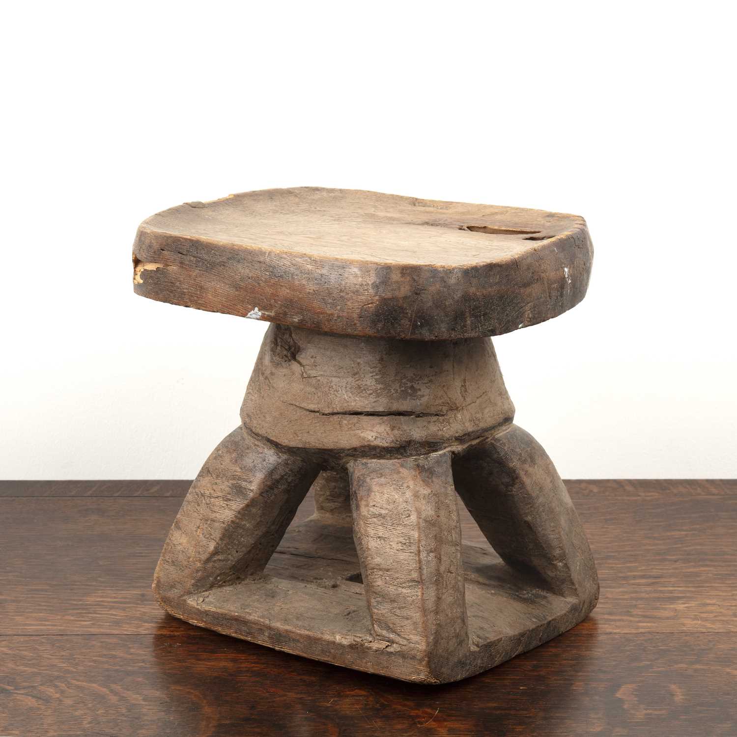Lot 83 - African hardwood stool of shaped form, on four...