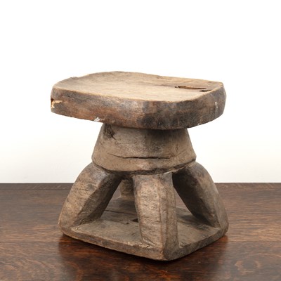 Lot 83 - African hardwood stool of shaped form, on four...