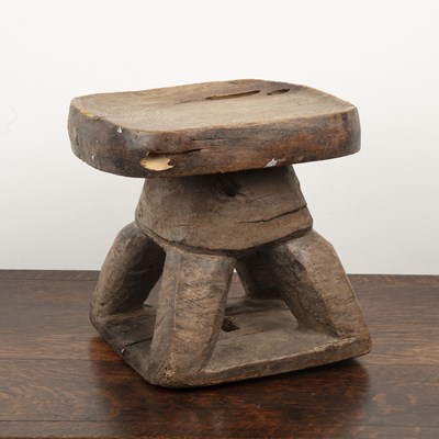 Lot 83 - African hardwood stool of shaped form, on four...