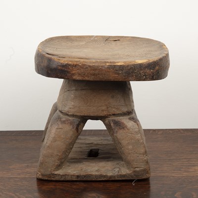 Lot 83 - African hardwood stool of shaped form, on four...