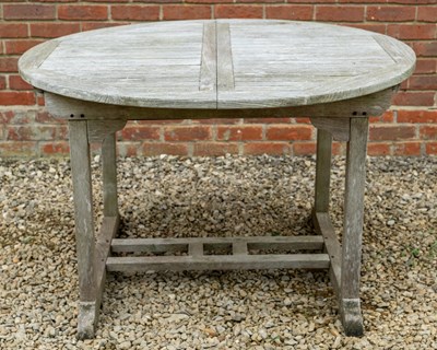 Lot 1278 - A weathered teak extending garden table