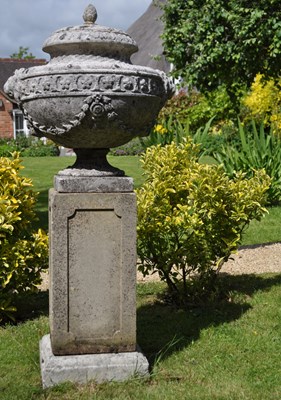 Lot A lidded urn or finial on a plinth base