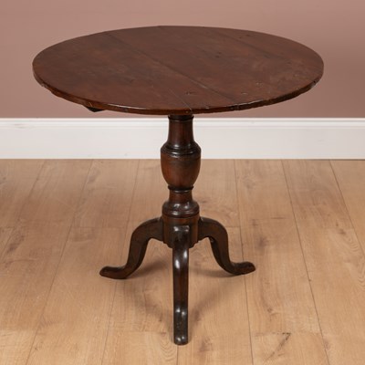 Lot 323 - A George III yew wood tilt-top circular tripod table