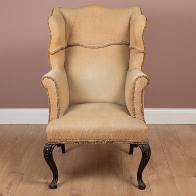 Lot 373 - A George III style wing back armchair