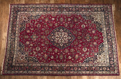 Lot 56 - Meshed-type red ground carpet with foliate...