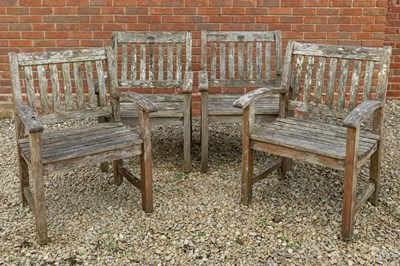 Lot 1229 - A set of four teak garden chairs