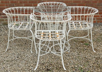 Lot 1217 - A white painted wrought iron set of four chairs and a circular table