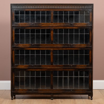 Lot 465 - An oak stacking sectional bookcase in two parts