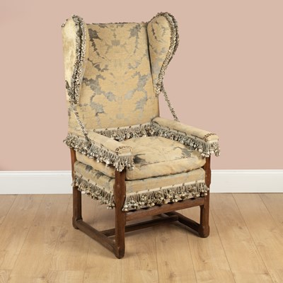 Lot 295 - A 17th century style wing back armchair