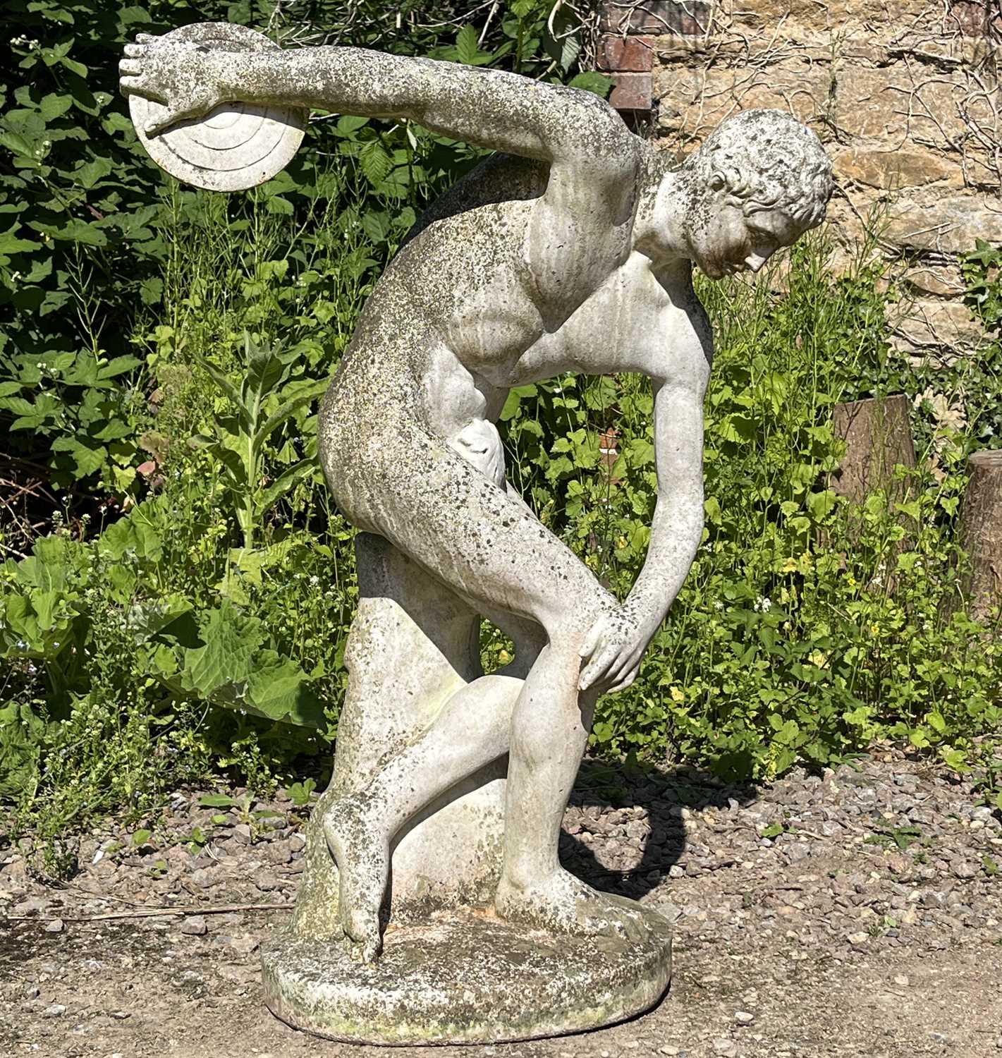 Lot 1365 - A cast reconstituted stone discobolus