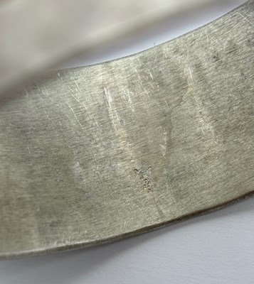 Lot 227 - A silver bangle by Breon O'Casey, the linear...