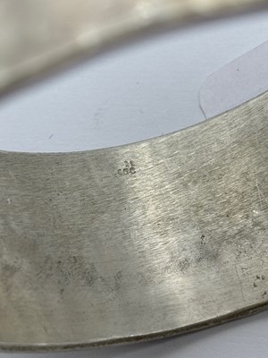 Lot 227 - A silver bangle by Breon O'Casey, the linear...