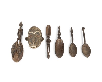 Lot 1117 - A monkey mask and a collection of spoons